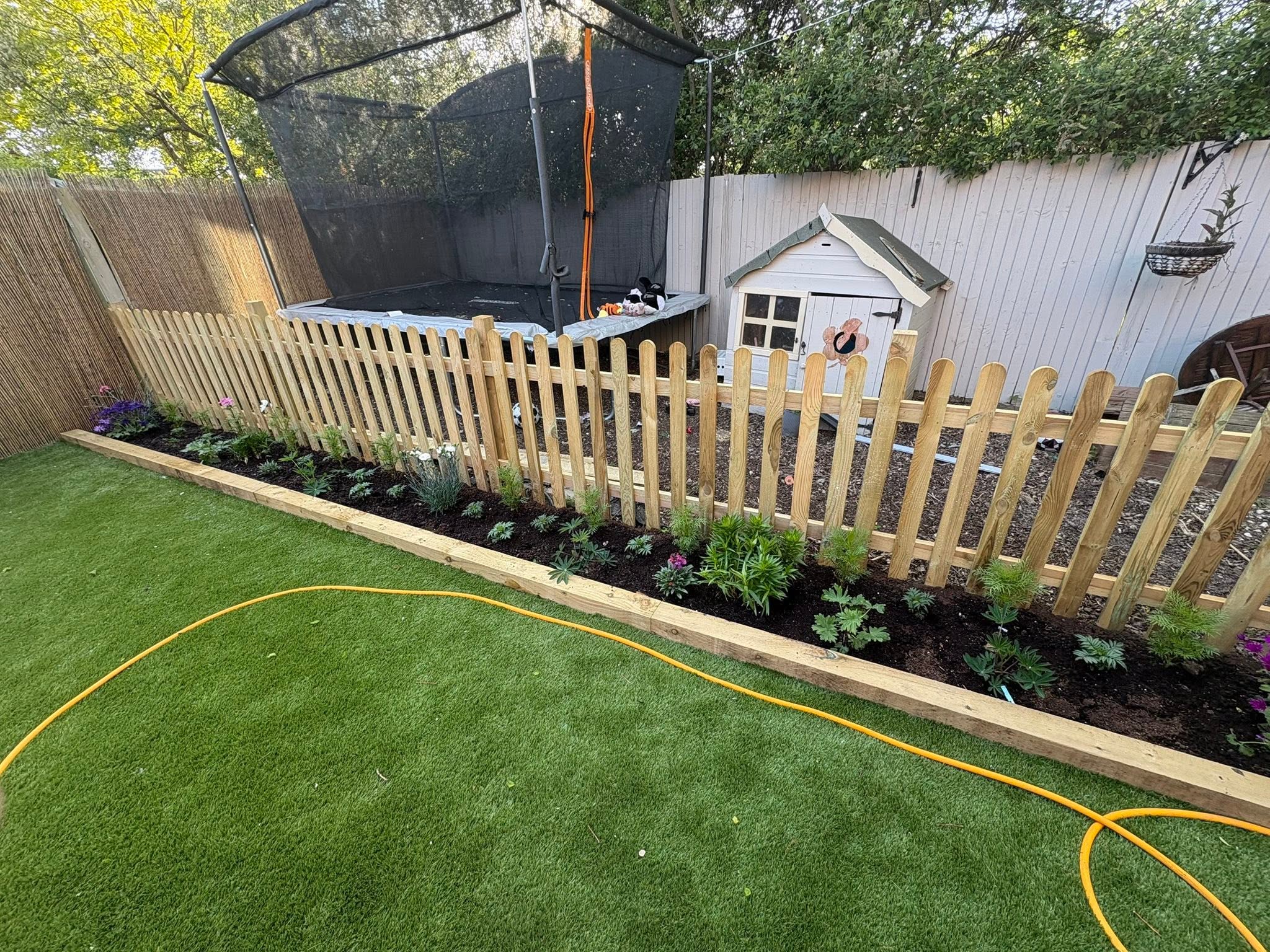 New picket fence and planted border